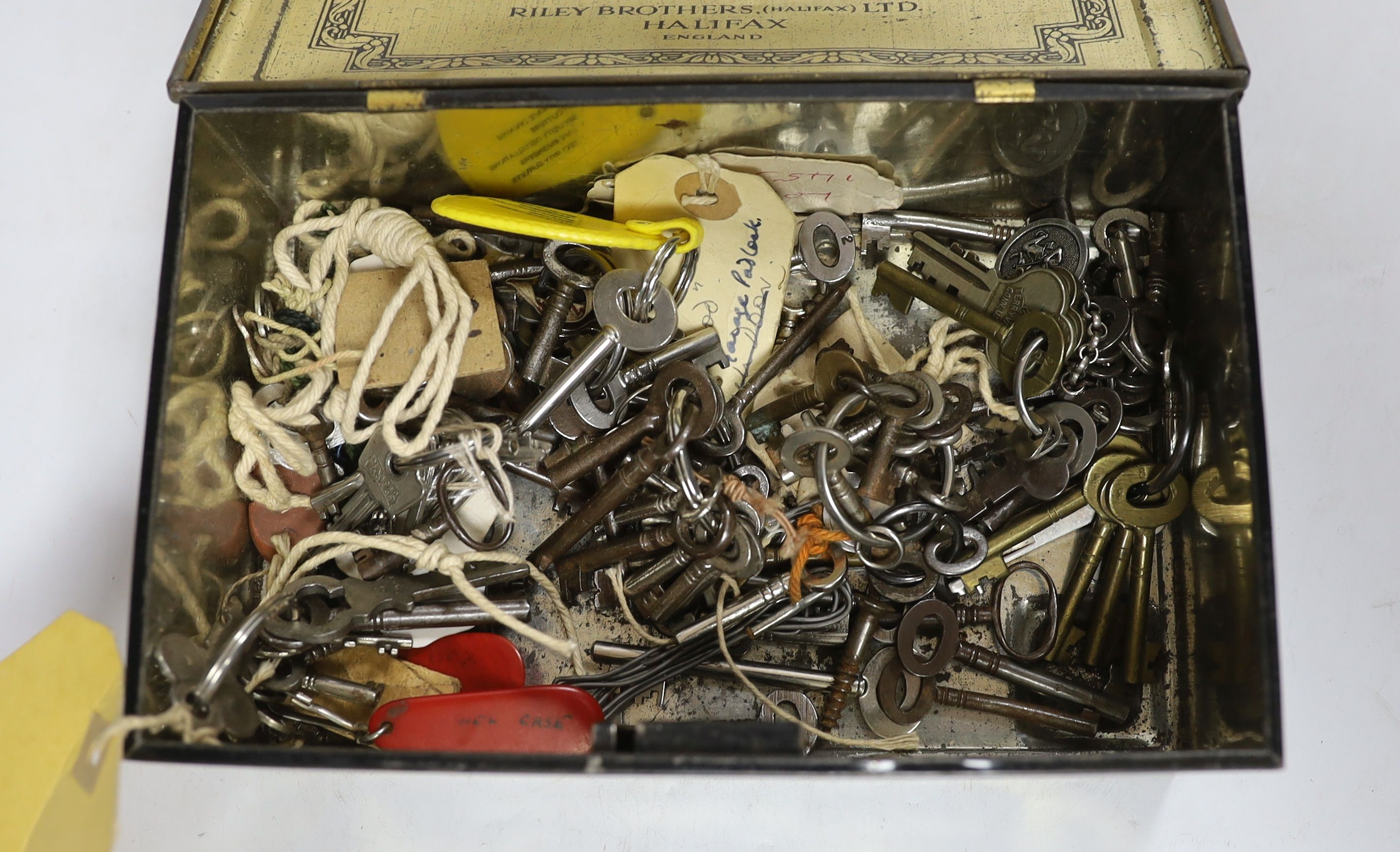 A collection of Victorian and later furniture and lock keys housed in a vintage tin